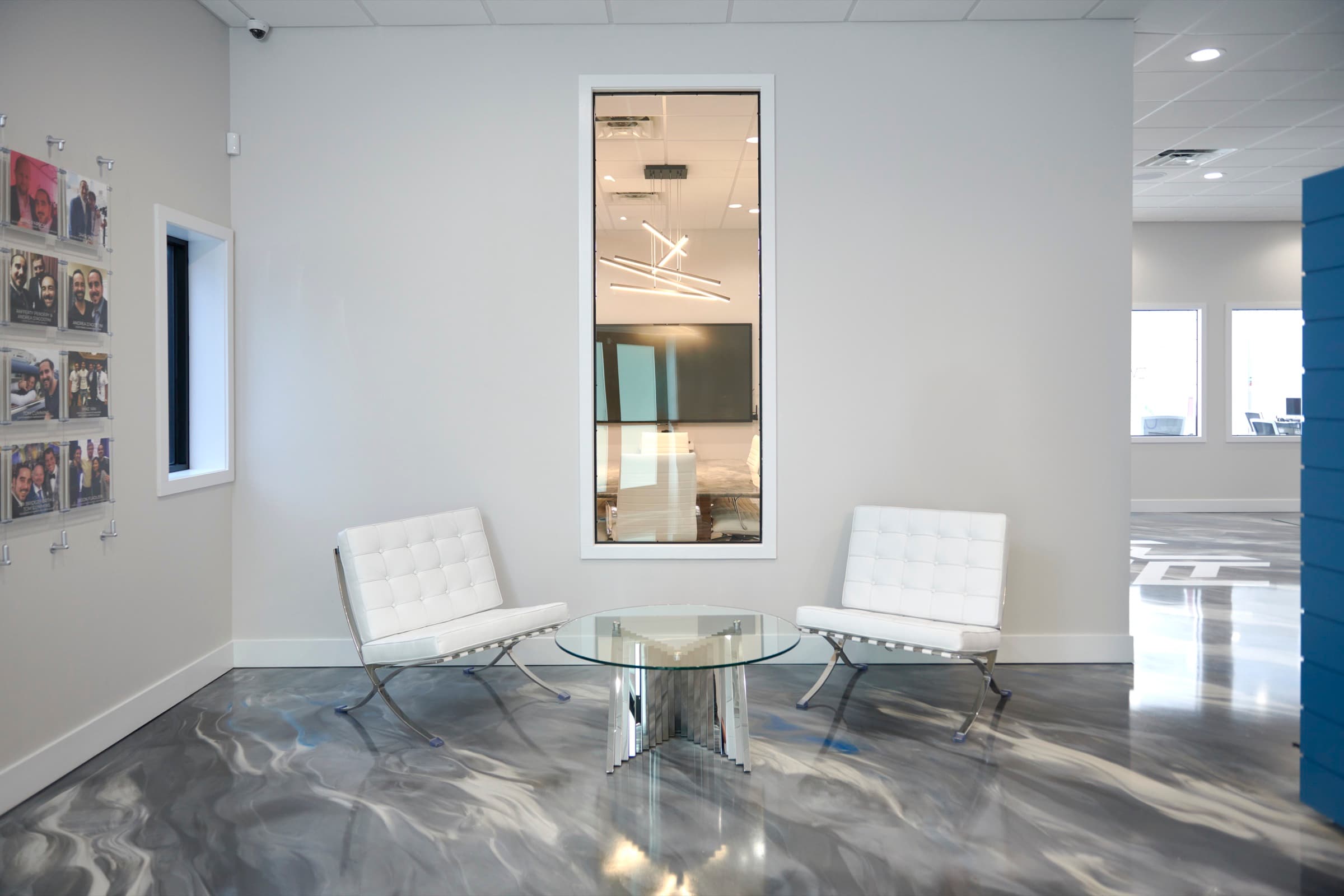 Lobby seating nook with white chairs on the marbled floor