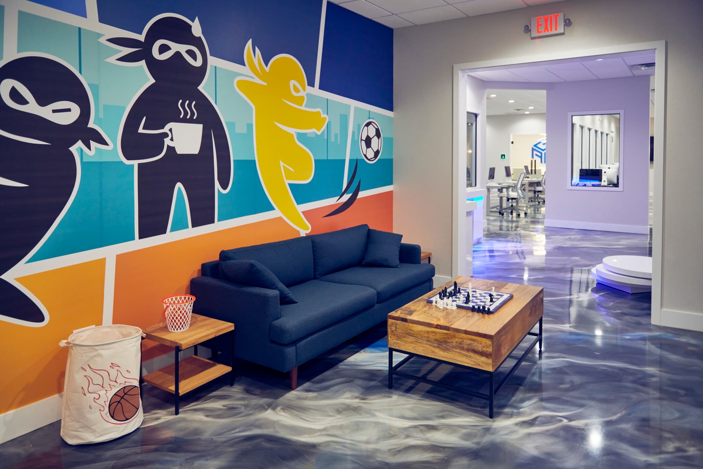 Lounge couch beneath the ninja-character brand mural
