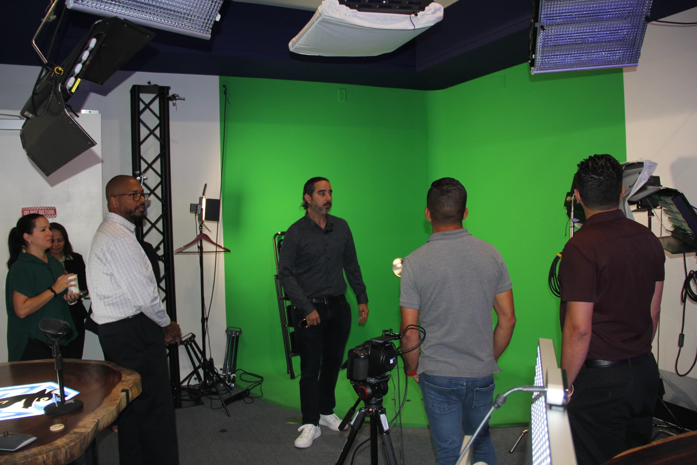 In-house green-screen video studio with lights and camera rigs